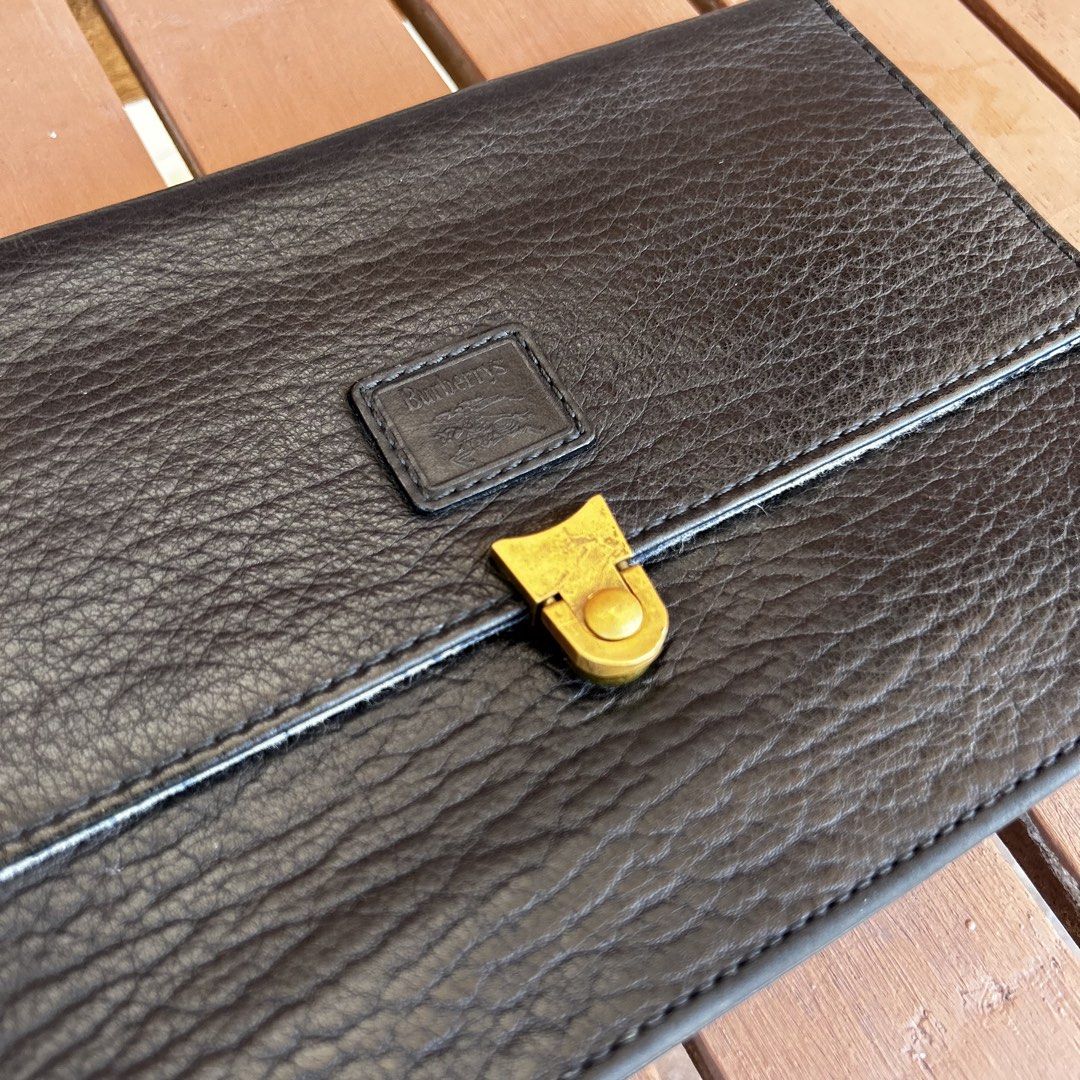 Vintage Burberry Clutch Bag Leather Authentic (Category: Luxury Bags & Wallets) located in Las Pinas. Submitted by _dontlikejustbuy (Listing ID 1436156295, Image 2). Description: Color: Leather Black Dimensions: - Height 17cm - Width 25cm - Depth 7cm - Strap 34cm Issues: Signs of usage. Stains on flap. .