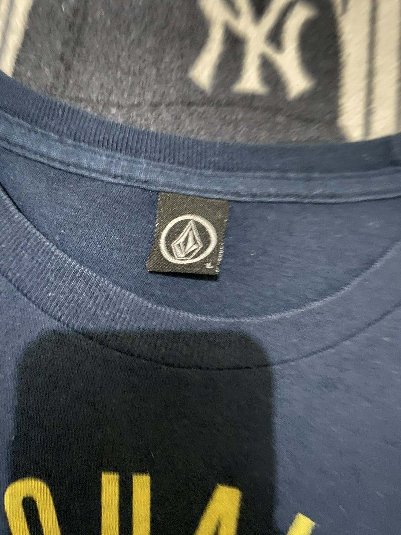 Volcom Premium Quality Goods T-shirt (Category: Tshirts & Polo Shirts ) located in Taguig. Submitted by cabugchear34421 (Listing ID 1436275062, Image 2). Description: - Navy blue Volcom t-shirt - Size: L - Graphic: Yellow circular design with "Premium Quality Goods" and Volcom logo - Style: Crew neck - Material: Soft - Condition: Good.