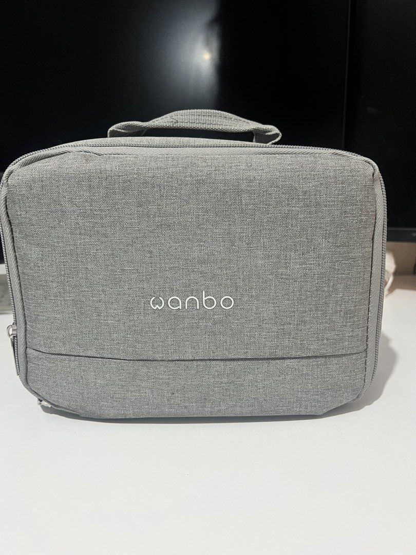 Wanbo T2 Max (Category: Projectors) located in Manila. Submitted by thriftwithmeeka (Listing ID 1436143532, Image 2). Description: Hey there! 👋 Selling my preloved Wanbo T2 Max projector! This little guy is perfect for small spaces or dorm rooms. It's got Android 9.0, so you can watch your fave shows on Netflix, YouTube, and more! The built-in speakers are super loud, so no need for external ones. Picture quality is clear even without a perfectl