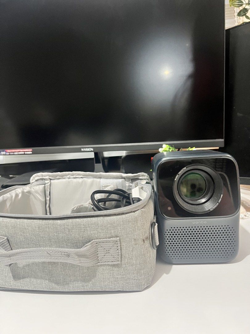 Wanbo T2 Max (Category: Projectors) located in Manila. Submitted by thriftwithmeeka (Listing ID 1436143532, Image 3). Description: Hey there! 👋 Selling my preloved Wanbo T2 Max projector! This little guy is perfect for small spaces or dorm rooms. It's got Android 9.0, so you can watch your fave shows on Netflix, YouTube, and more! The built-in speakers are super loud, so no need for external ones. Picture quality is clear even without a perfectl