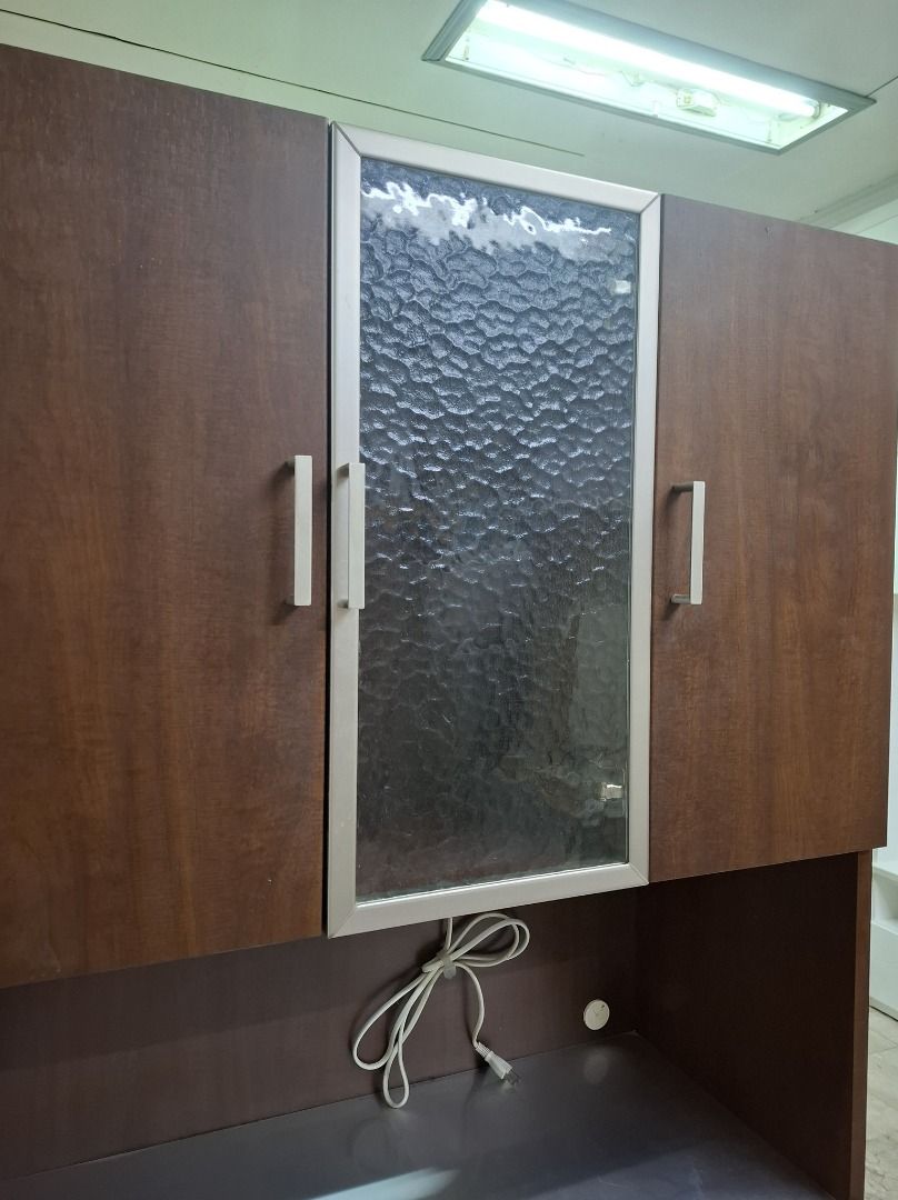 Wooden Cabinet with Drawers and Glass Door (Category: Shelves, Cabinets & Racks) located in Quezon City. Submitted by japandemanila (Listing ID 1436103289, Image 3). Description: - Dark brown wooden cabinet - Features a glass door cabinet - Includes open shelves - Has drawers for storage - Comes with a pull-out tray - Built-in power outlet - Ideal for various storage needs JAPAN SURPLUS *6 Magdiwang st. Philvirra Homes Quezon City *in good condit
