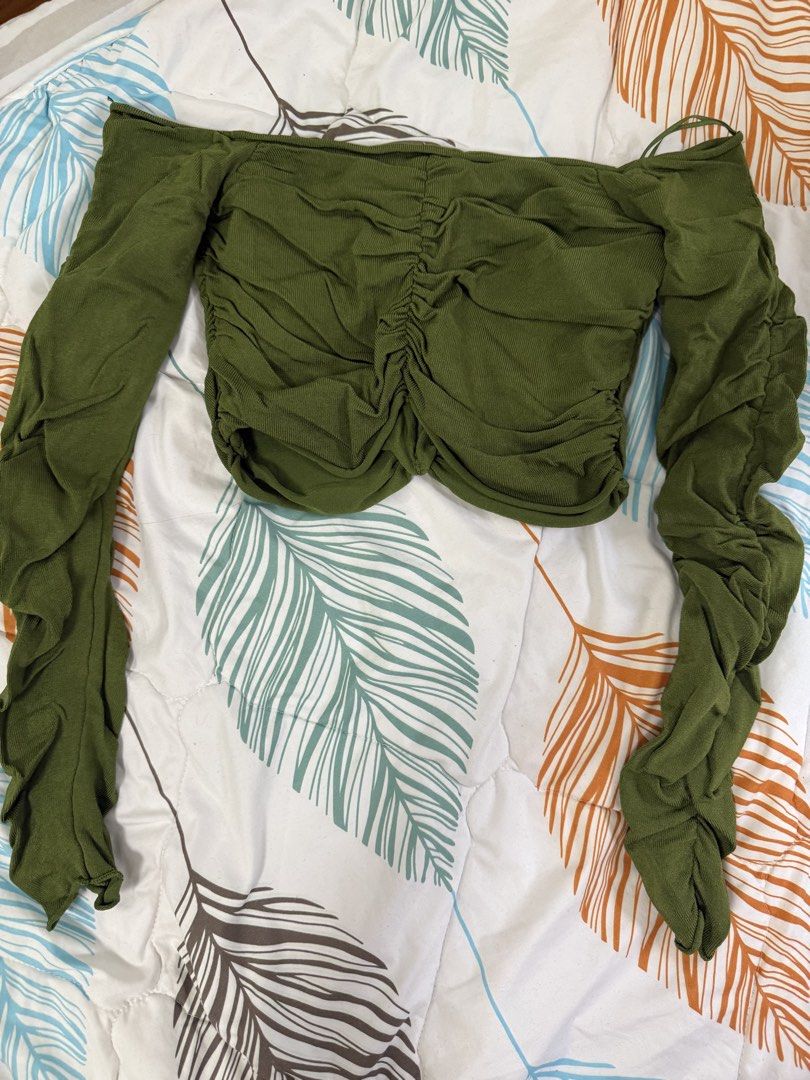 Zara Olive Green Off-Shoulder Top (Category: Blouses) located in Quezon City. Submitted by prelovedbyshannen_ (Listing ID 1436169242, Image 2). Description: - Olive green off-shoulder top - Long sleeves with gathered texture - Ruched front design - Cropped length - Made of soft, stretchy fabric - Solid color, versatile for different outfits.