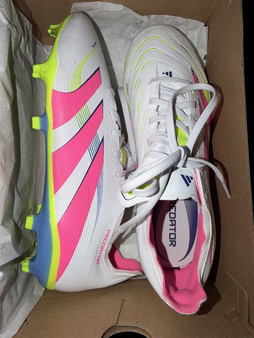 Adidas Predator Football Boots (Category: Boots) located in Makati City. Submitted by arychives (Listing ID 1436313361, Image 3). Description: -24.5cm - Adidas Predator football boots - Color: White with pink and yellow accents - Includes original box - Includes a pair of adidas shin guards and decathlon socks - Features Predator logo on insole and side - Designed for football/soccer -Used twice.