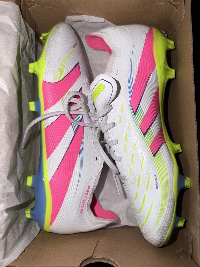 Adidas Predator Football Boots (Category: Boots) located in Makati City. Submitted by arychives (Listing ID 1436313361, Image 2). Description: -24.5cm - Adidas Predator football boots - Color: White with pink and yellow accents - Includes original box - Includes a pair of adidas shin guards and decathlon socks - Features Predator logo on insole and side - Designed for football/soccer -Used twice.