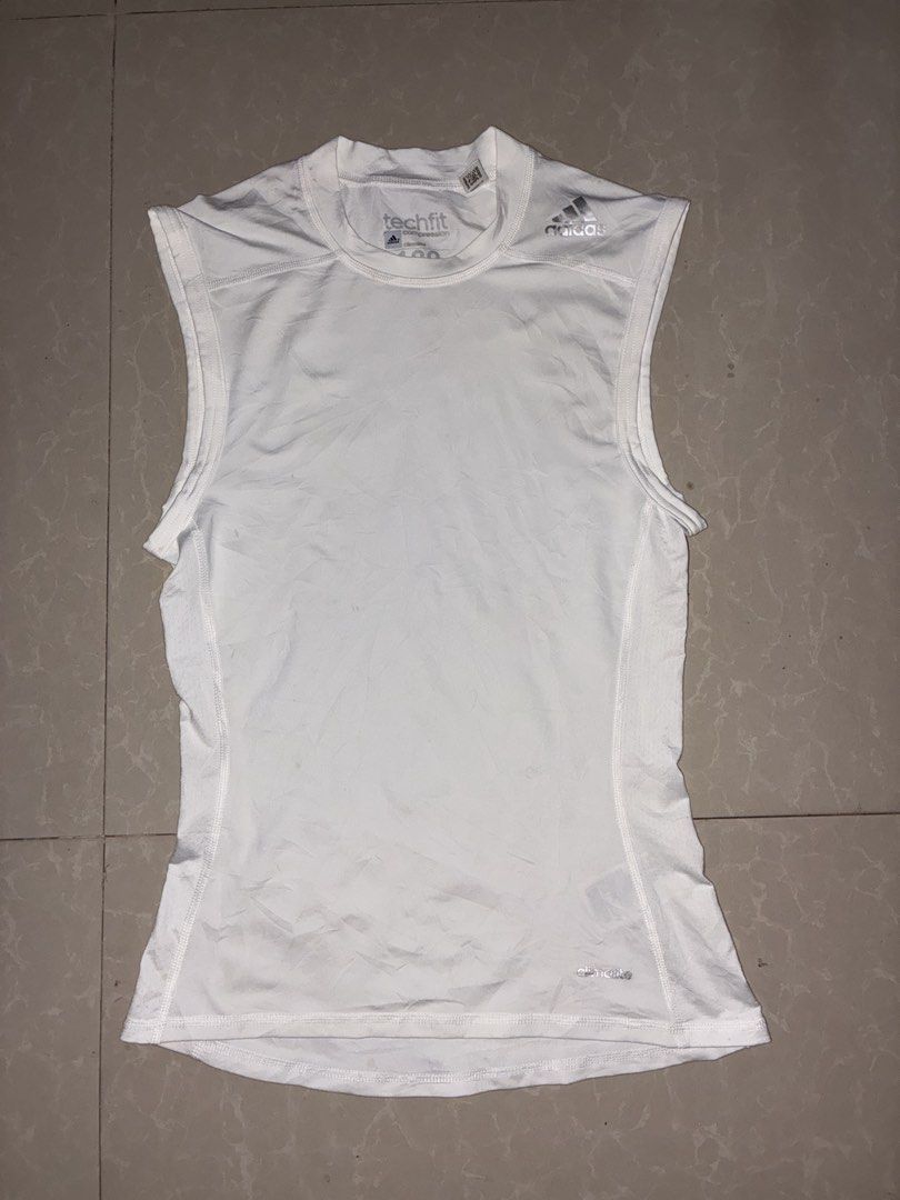 Adidas Techfit Sleeveless Shirt (Category: Activewear) located in Placer. Submitted by talaalond61563 (Listing ID 1436411780, Image 1). Description: - Adidas Techfit sleeveless shirt - White color - Crew neck - Adidas logo on shoulder - Climalite logo at the bottom - Compression shirt - Size 100 - Made in the Philippines.