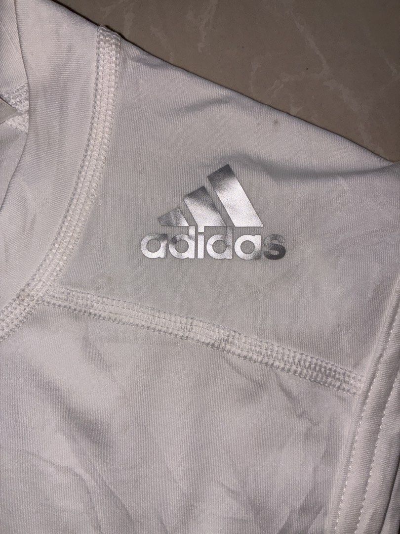 Adidas Techfit Sleeveless Shirt (Category: Activewear) located in Placer. Submitted by talaalond61563 (Listing ID 1436411780, Image 3). Description: - Adidas Techfit sleeveless shirt - White color - Crew neck - Adidas logo on shoulder - Climalite logo at the bottom - Compression shirt - Size 100 - Made in the Philippines.