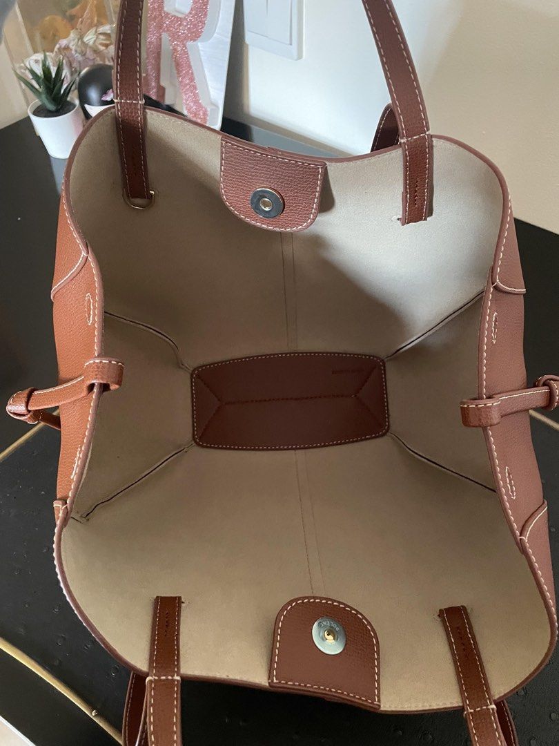 Authentic Polène Cyme Handbag (Category: Luxury Bags & Wallets) located in Manila. Submitted by jessehh (Listing ID 1436410963, Image 2). Description: - Unique-shaped brown leather handbag - White stitching detail - Matching brown interior - Dual top handles - Detachable shoulder strap - Magnetic closure Bought from Korea With receipt, dust bag and tag (no more box and paper bag) .