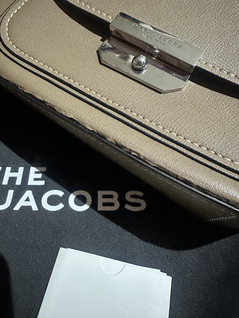 Authentic The Marc Jacobs Saddle Bag (Category: Luxury Bags & Wallets) located in Quezon City. Submitted by rempgo (Listing ID 1436452033, Image 3). Description: - Authentic The Marc Jacobs Saddle Bag - Slightly used - Neutral taupe exterior - Classic saddle bag design - Flap closure with silver-tone metal clasp - Includes dust bag and tag - Interior zippered pocket - Versatile top handle and shoulder strap - with minimal damage due to long stora