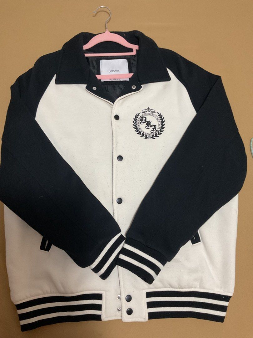 Bershka Varsity Jacket (Category: Coats, Jackets and Outerwear) located in Quezon City. Submitted by prelovedbykhy (Listing ID 1436398064, Image 1). Description: - Bershka varsity jacket - Black and white color block design - Size M - "New Wave" emblem on the back - "DAA" embroidery - Button-up front - Striped cuffs.
