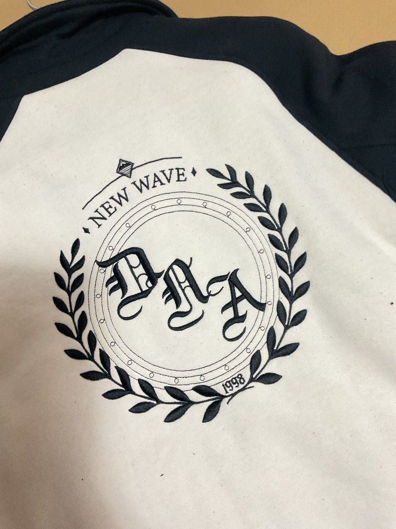 Bershka Varsity Jacket (Category: Coats, Jackets and Outerwear) located in Quezon City. Submitted by prelovedbykhy (Listing ID 1436398064, Image 2). Description: - Bershka varsity jacket - Black and white color block design - Size M - "New Wave" emblem on the back - "DAA" embroidery - Button-up front - Striped cuffs.