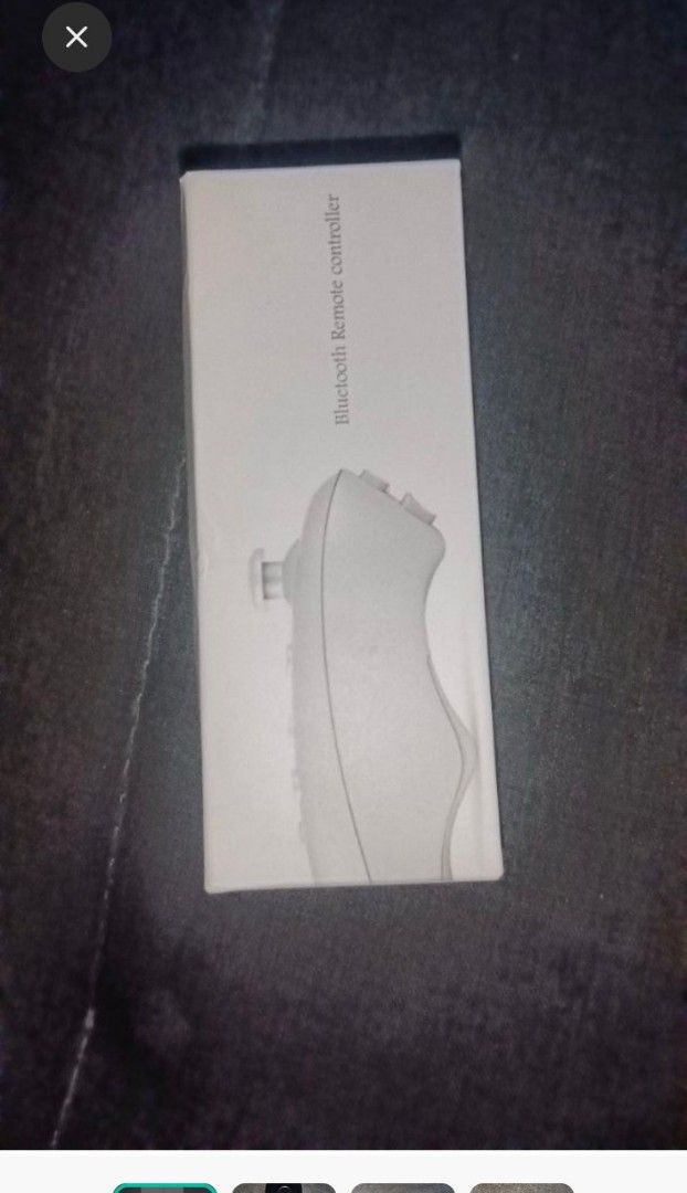 Bluetooth Remote Controller (Category: Controllers) located in Kuala Langat. Submitted by aqasha1713 (Listing ID 1436420755, Image 1). Description: Bluetooth remote controller. It has multiple buttons, including a joystick and buttons labeled A, B, C, and D. The controller is black and comes in a white box. The box indicates it is a Bluetooth remote controller..