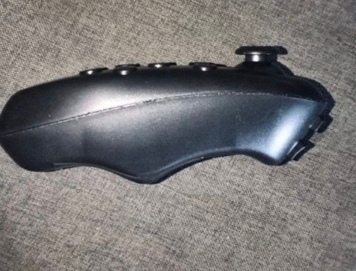 Bluetooth Remote Controller (Category: Controllers) located in Kuala Langat. Submitted by aqasha1713 (Listing ID 1436420755, Image 2). Description: Bluetooth remote controller. It has multiple buttons, including a joystick and buttons labeled A, B, C, and D. The controller is black and comes in a white box. The box indicates it is a Bluetooth remote controller..