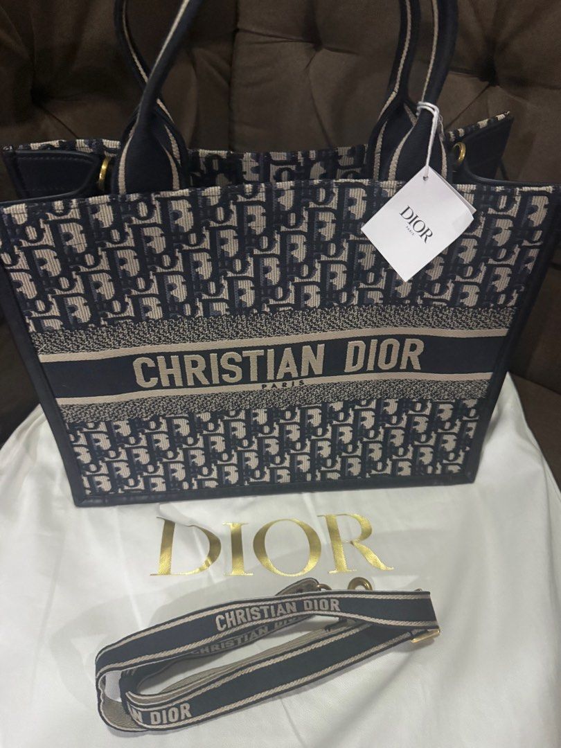 Brand New Authentic Dior Book Tote (Category: Luxury Bags & Wallets) located in Pasig City. Submitted by 7117blo (Listing ID 1436392141, Image 2). Description: Brand new Dior Book Tote with Shoulder strap. New version. SRP at 240000. Pick up at St Ignatius Village, QC.
