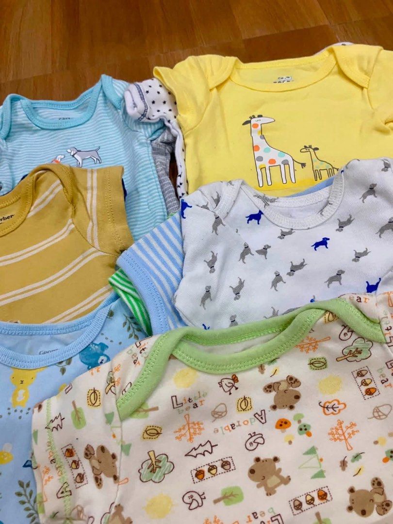 Carter's Baby Onesies - Assorted Designs (Category: Babies & Kids Fashion) located in Manila. Submitted by royalmountain_71a89e (Listing ID 1436394708, Image 3). Description: -55pcs - Bundle of baby onesies - Features animal and stripe designs - Colors: yellow, blue, green, white - Made of soft fabric - Short sleeves - Designs include giraffes, owls, dogs, and dinosaurs - Ideal for everyday wear.