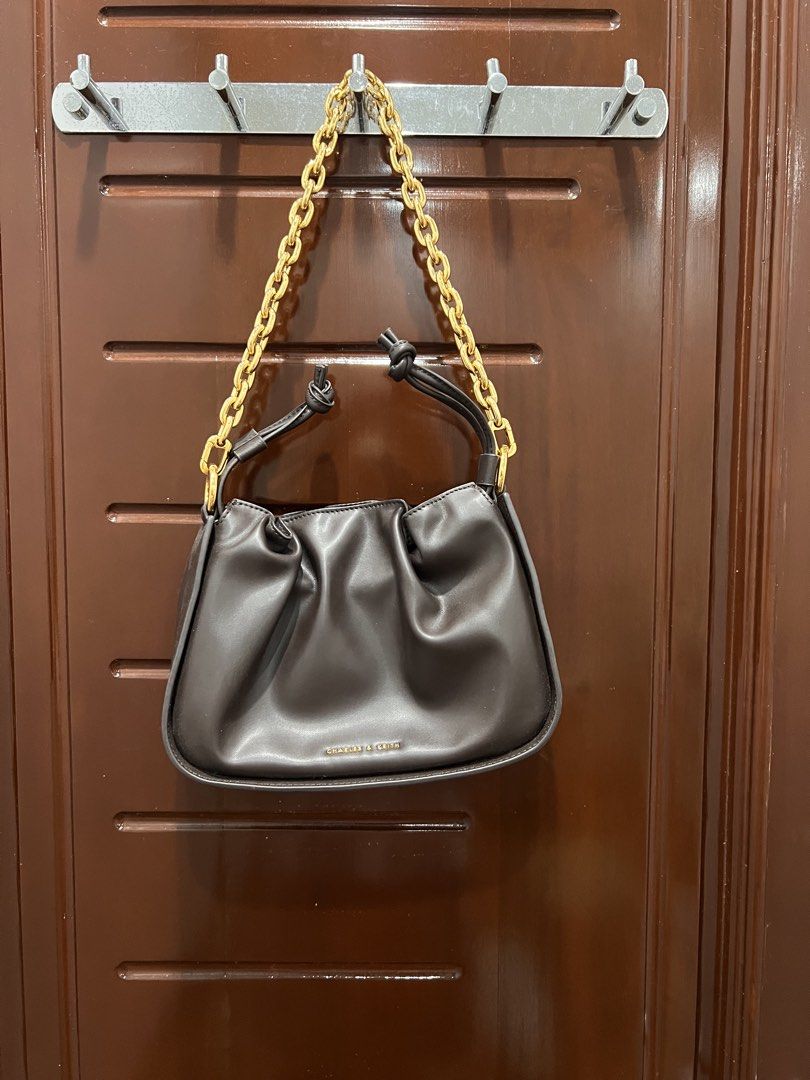 Charles & Keith Dark Brown Handbag (Category: Luxury Bags & Wallets) located in Manila. Submitted by limonee (Listing ID 1436394526, Image 1). Description: Has a few stains inside RFS: decluttering Loc: Tondo MOP: GCash, Maribank, Maya MOD: J&T, Lalamove, Grab.