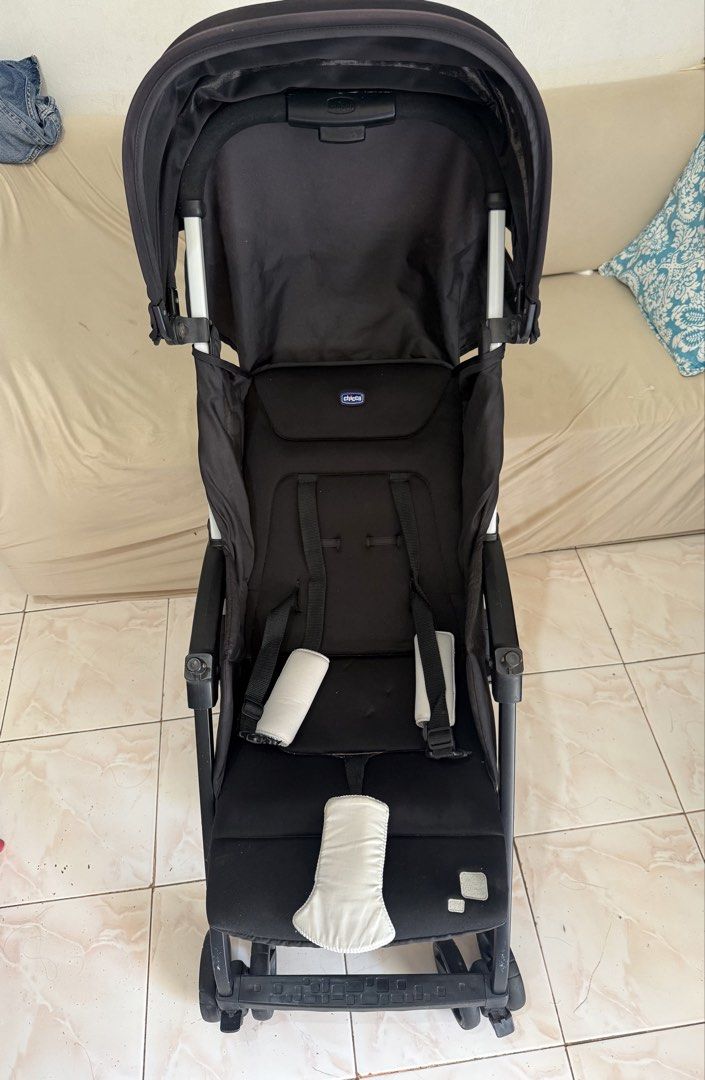Chicco Stroller (Category: Strollers) located in Manila. Submitted by drewgreig95 (Listing ID 1436341174, Image 2). Description: Black Chicco stroller with a sunshade. Features a padded seat and safety straps. Includes a small storage basket underneath. The wheels are visible, and the frame is black. Original Mall Price: 12,000.