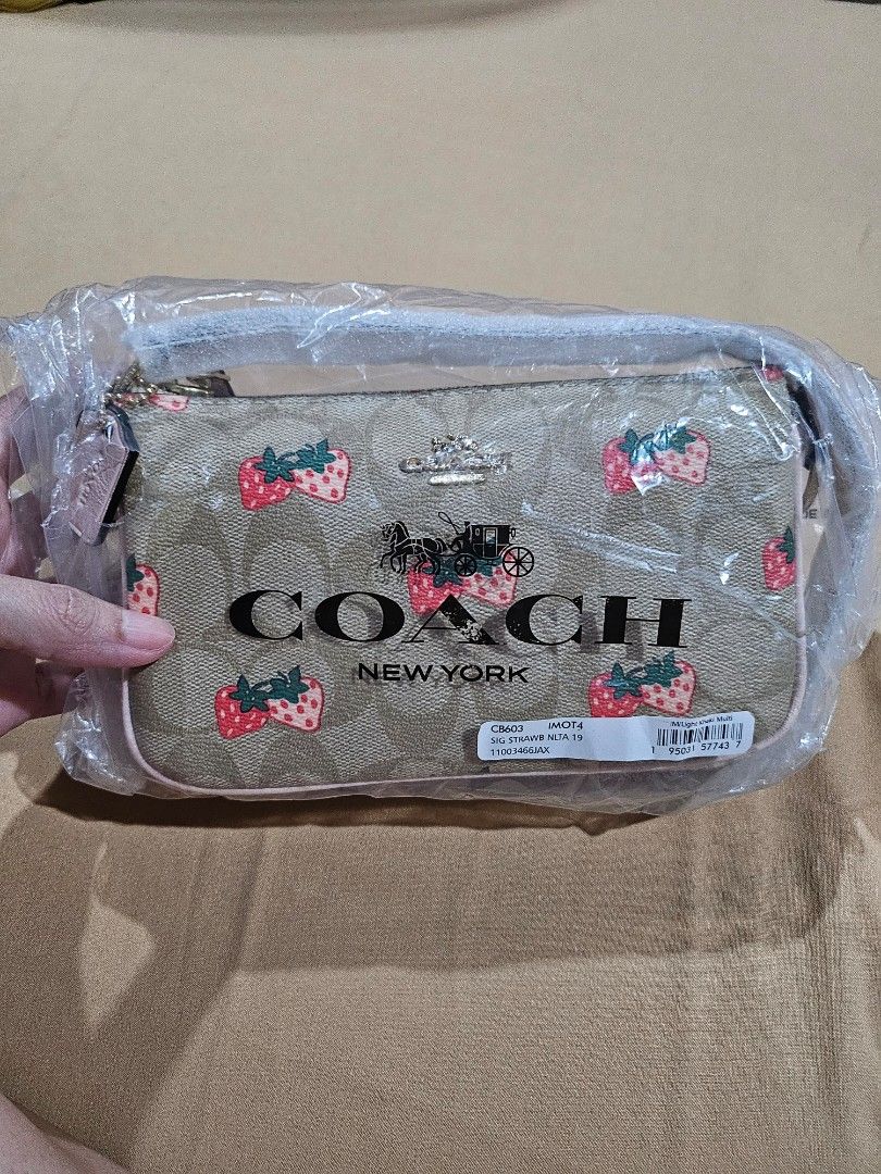 Coach Nolita 19 (Category: Luxury Bags & Wallets) located in Malabon City. Submitted by dadasoliveria (Listing ID 1436433882, Image 1). Description: - Brand: Coach - Model: Nolita 19 - Condition: Brand new, with original packaging - Design: Features a playful strawberry pattern with light pink strap - Style: Shoulder bag - Material: Authentic Coach material - Perfect for carrying essentials - Stylish and functional.