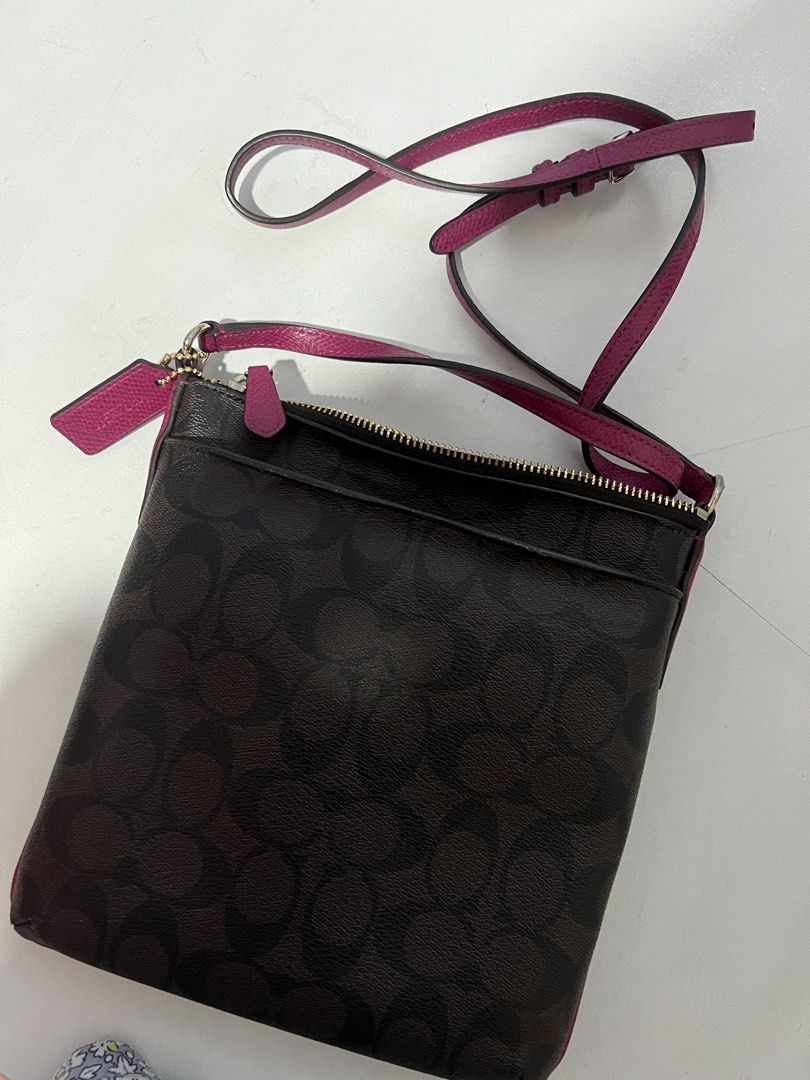 Coach Signature Crossbody Bag (Category: Luxury Bags & Wallets) located in Quezon City. Submitted by roseela (Listing ID 1436424706, Image 2). Description: - Authentic Coach crossbody bag - Signature Coach brown pattern - Pink strap and trim - Zippered main compartment - Includes small Coach tag - Adjustable strap - Slim profile, perfect for daily use - MOP: GCASH/BDO - LOC: QC.