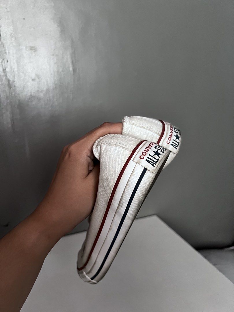 Converse Chuck Taylor All Star White Sneakers (Category: Sneakers) located in Taytay. Submitted by zdeclut (Listing ID 1436376654, Image 3). Description: - Classic white Converse Chuck Taylor All Star sneakers - Bought from Korea - condition 9/10 - used 2 times only indoor - Size: 8.5 - Features iconic Converse logo - White upper with red and black sole stripe - Includes original box - Laced up and ready to wear.