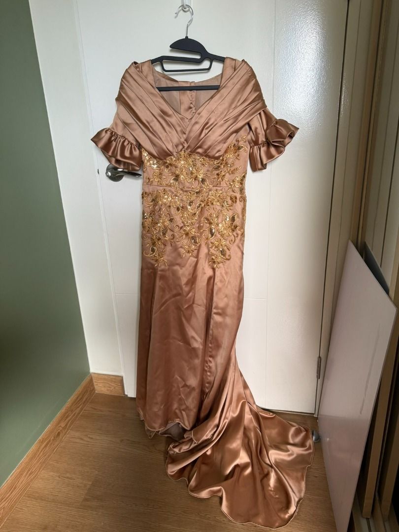 Elegant Champagne Evening Gown (Category: Evening dresses & gowns) located in Manila. Submitted by rcbc1128 (Listing ID 1436383047, Image 3). Description: NEVER BEEN WORN - Champagne-colored evening gown - Intricate gold embroidery on bodice - Flowing skirt with train - Unique off-the-shoulder design with ruffled sleeves - Ideal for special occasions and formal events - Designed to flatter the figure body size: bust - 34"/ waist 30"/ hip 36" Nego
