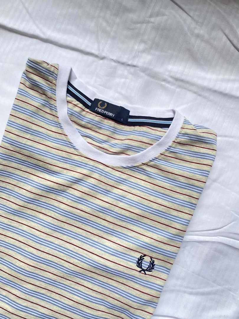 Fred Perry Striped T-shirt - Size L (Category: Tshirts & Polo Shirts ) located in Iligan City. Submitted by brandx1993 (Listing ID 1436351244, Image 2). Description: - Fred Perry striped t-shirt - Size: L - Crew neck - Embroidered navy blue laurel wreath logo - Striped pattern: beige, blue, and maroon - White collar -Excellent Condition 10/10 Large 21-21.5/28.5.