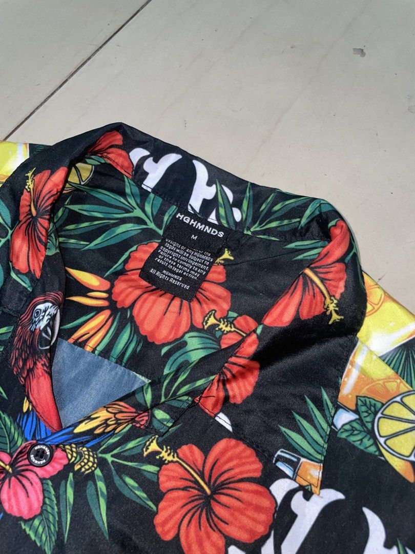 HGHMNDS Hawaiian Shirt - Medium (Category: Swim Top & Rash Guards) located in Makati City. Submitted by vastflower-e858 (Listing ID 1436461778, Image 3). Description: - HGHMNDS Hawaiian shirt - Size: Medium - Features a colorful tropical print - Design: Parrots, hibiscus flowers, and cocktails - Background: Black - Style: Button-down, short sleeves.