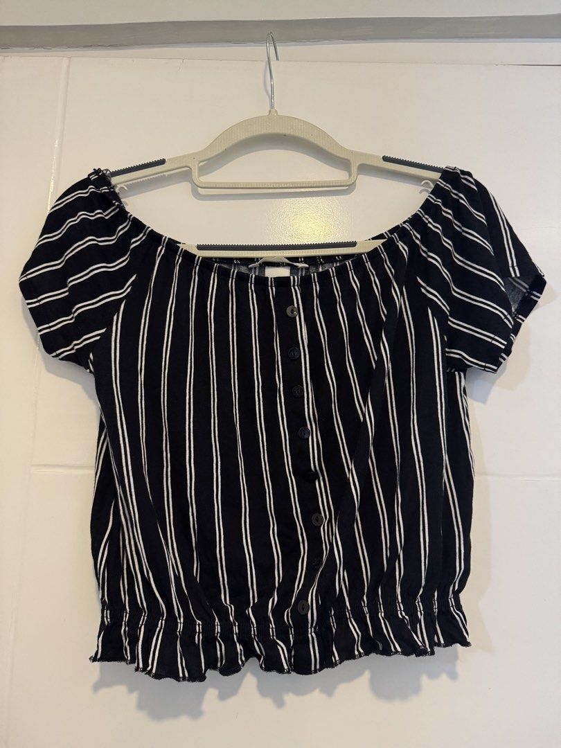 H&M Off Shoulder Top (Category: Blouses) located in Makati City. Submitted by sphpnd (Listing ID 1436463867, Image 2). Description: - H&M off-shoulder top - Black and white stripes - Size: XS - Features: Button-down front, elasticated hem - Fabric: Lightweight - Sleeves: Short - Suitable for warm weather.