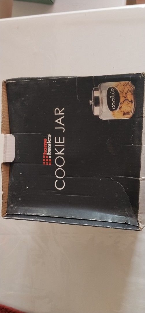 Home Basics Cookie Jar with Metal Lid (Category: Food Organization & Storage) located in Pasig City. Submitted by magsajokat46354 (Listing ID 1436299231, Image 2). Description: - Home Basics cookie jar - Clear glass design - Metal lid - Features a "Cookie" label - Heavy-duty, thick glass - never used with original box.