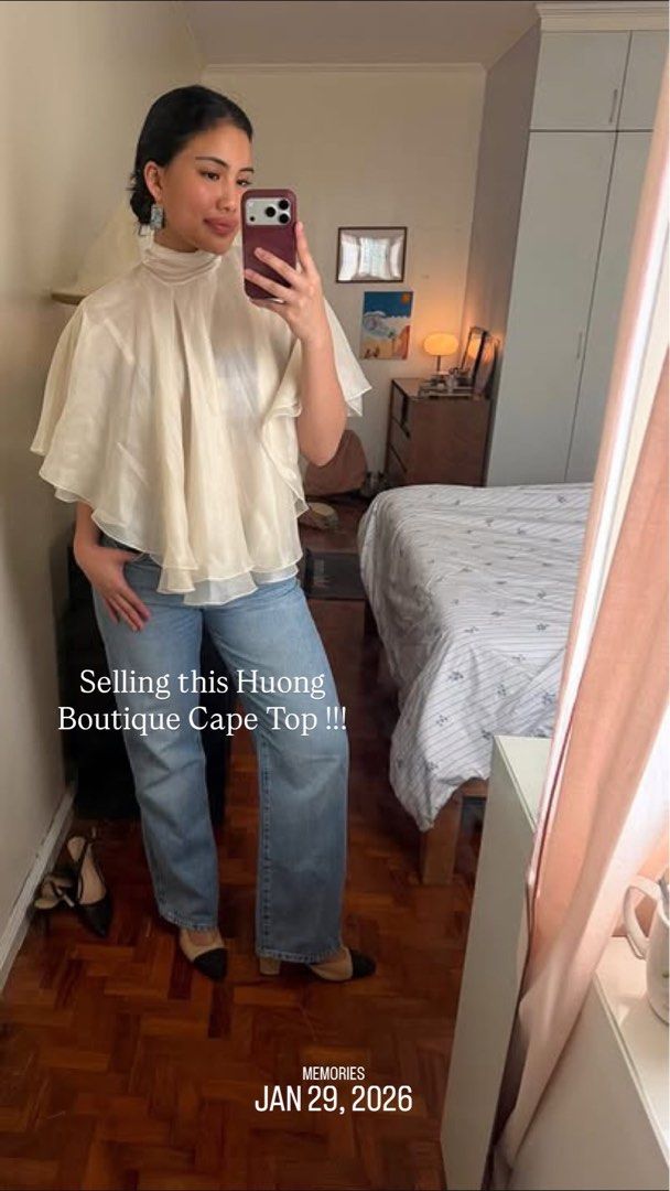 Huong Boutique Kieu Silk Blouse (Category: Blouses) located in Quezon City. Submitted by ladybd (Listing ID 1436369403, Image 2). Description: - Huong Boutique silk blouse - Size: S - Color: Off-white - Design: Cape with layered ruffles - Features: High neck, tie back - Ideal for: Special occasions or everyday wear.