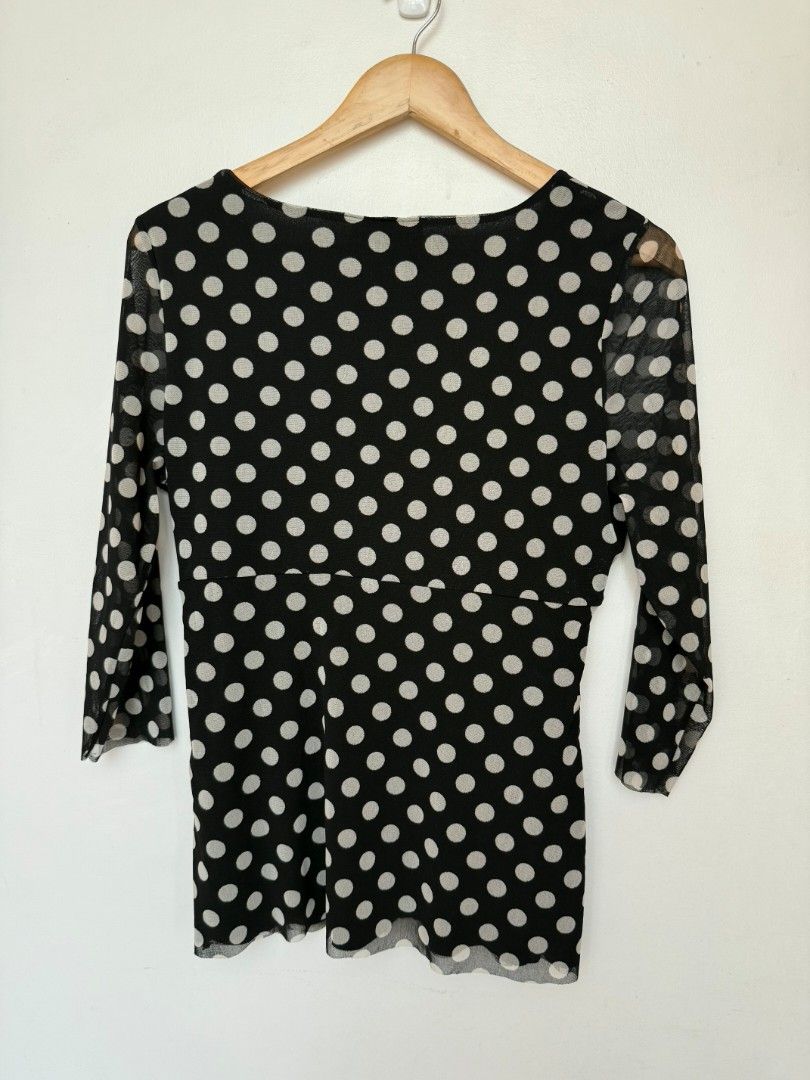 (M) INC International Concepts Polka Dot Blouse (Category: Blouses) located in Angeles City. Submitted by holaplli (Listing ID 1436405009, Image 3). Description: - Black blouse with white polka dots - Wrap design with a flattering V-neck - Features long sleeves - Made of a sheer material - Cinched waist for a great fit - Perfect for various occasions ⭐️ -Size Large on tag, Fits S-L -Nylon material 🚚Shipping via J&T express 💰Payment via Seabank,