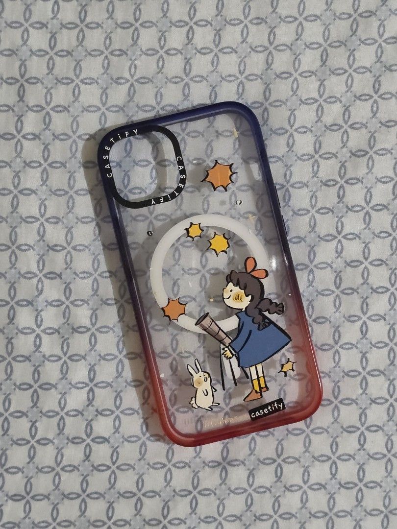 iPhone 13/14 Original Casetify iPhone Magsafe Case (Category: Cases & Sleeves) located in Manila. Submitted by mgraciec (Listing ID 1436316487, Image 1). Description: - Original Casetify iPhone case. - Compatible with iPhone 13 and 14. - Features a charming design. - Depicts a girl, bunny, and stars. Magsafe case Used but not abused, might have scratches since this is a clear acrylic case.