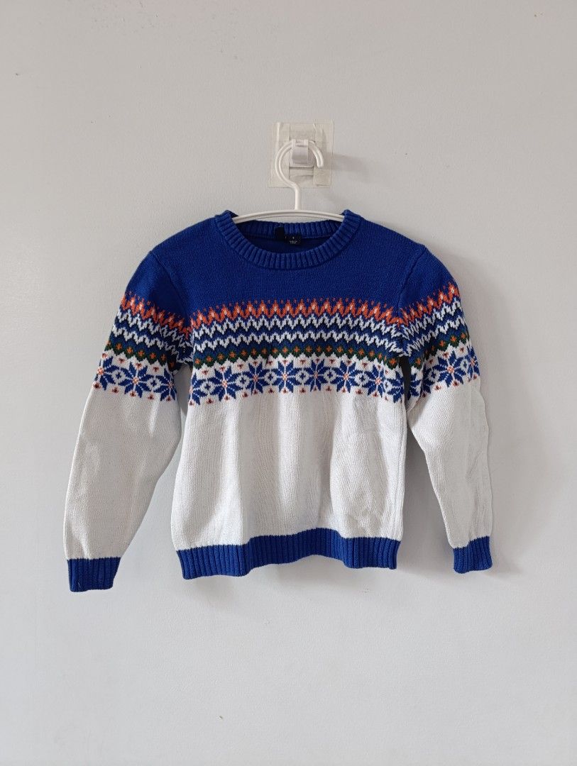 Janie and Jack Fair Isle Sweater - Size 6 (Category: Babies & Kids Fashion) located in Manila. Submitted by stuffsbybrix (Listing ID 1436367293, Image 1). Description: - Janie and Jack Fair Isle sweater - Size 6 - Crew neck, long sleeves - Color scheme: Blue base, white body, orange and blue patterned yoke - Design: Snowflakes and geometric patterns - Condition: Minor thread pull on front rfs: decluttering/outgrown .