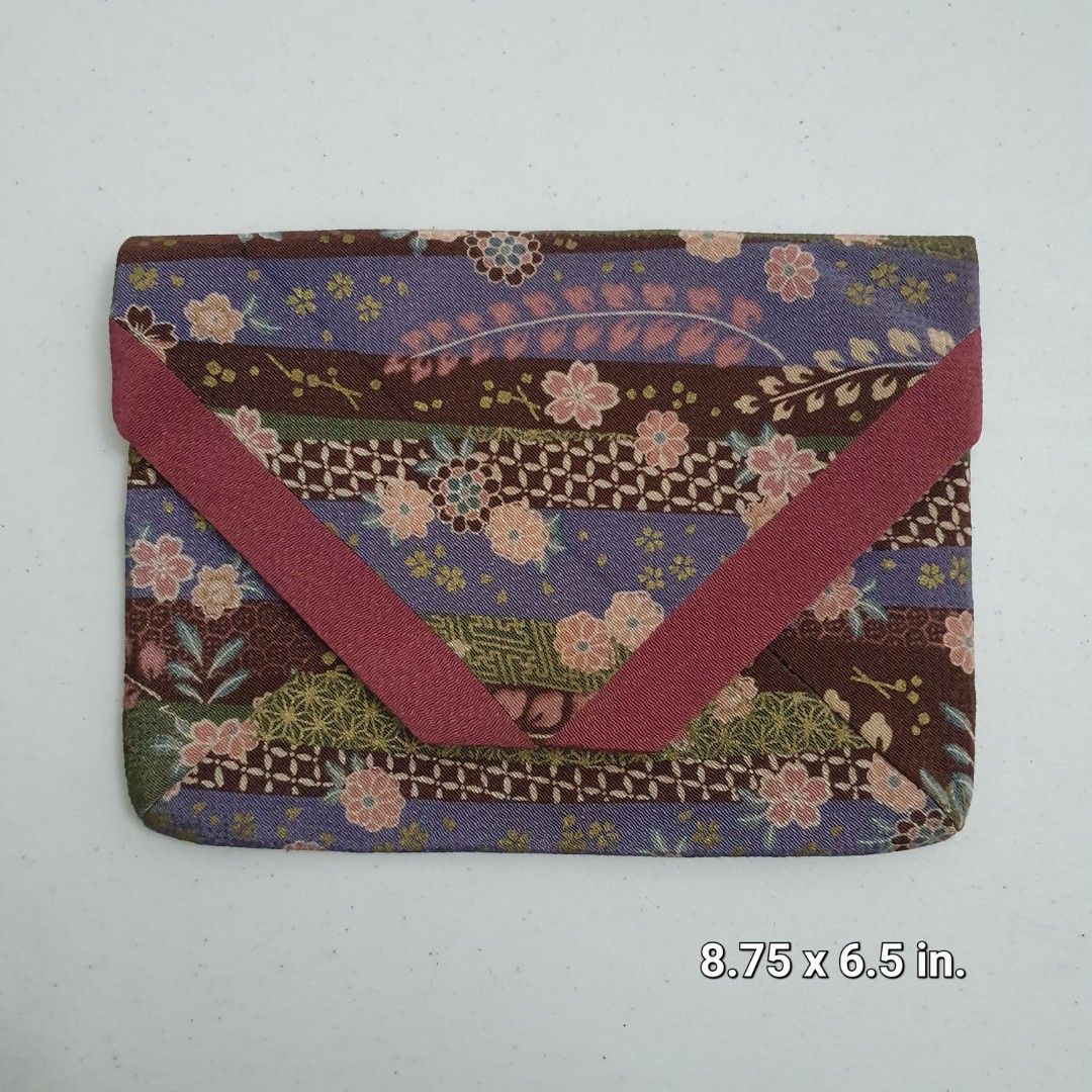 Japanese Fabric Clutch (Category: Clutches) located in Paranaque City. Submitted by cobien (Listing ID 1436399237, Image 1). Description: - Japanese fabric design - Floral and geometric patterns - Colors: Purple, brown, and green - Dark blue interior - Flap closure with button - Size: Approximately 8.75 x 6.5 inches.