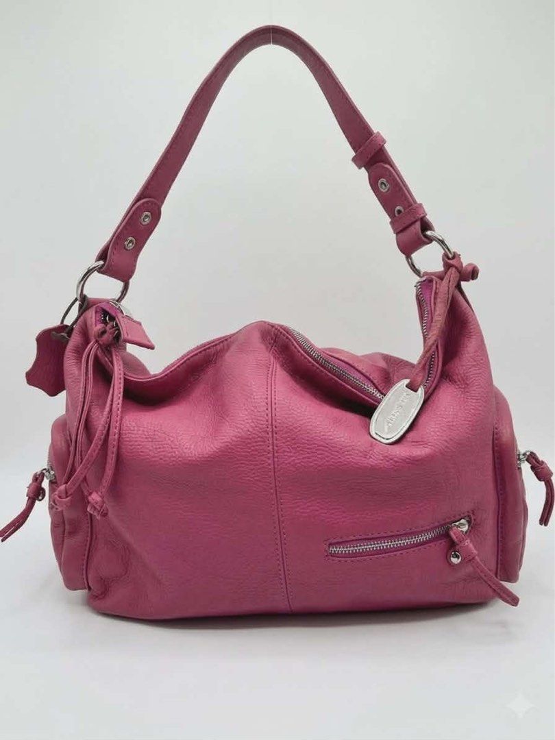 Jill Scott's Pink Leather Hobo Bag (Category: Luxury Bags & Wallets) located in Cavite. Submitted by bags_unltd143 (Listing ID 1436292580, Image 1). Description: Jill Scott hobo bag is crafted from pink leather. It features a top handle, a main compartment with a zipper closure, and exterior pockets. The bag has a silver-tone logo tag and silver hardware..