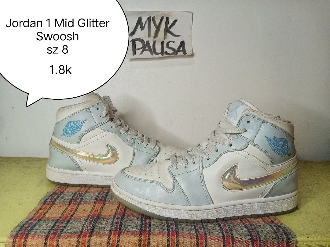 Jordan 1 Mid Glitter Swoosh - Size 8 (Category: Sneakers) located in General Santos City (Dadiangas). Submitted by michaelmp2026 (Listing ID 1436292447, Image 1). Description: - Jordan 1 Mid Glitter Swoosh - Size 8 - Color: Light blue and white - Features a glitter swoosh - Jordan logo on side and tongue - Made in Indonesia.
