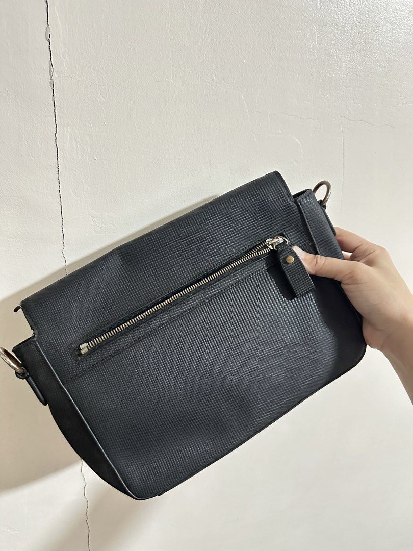 Lacoste Black Handbag (Category: Luxury Bags & Wallets) located in Quezon City. Submitted by camille96 (Listing ID 1436302253, Image 2). Description: - Black Lacoste handbag - Original price: 7,000 - Flap closure - Gold-toned clasp - Small Lacoste logo - Textured surface - Single handle .