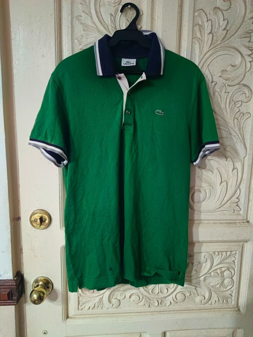 Lacoste Green Polo Shirt (Category: Tshirts & Polo Shirts ) located in Caloocan City. Submitted by omenggod (Listing ID 1436448345, Image 1). Description: - Green Lacoste polo shirt - Navy blue and white collar and sleeve trim - Features the iconic Lacoste crocodile logo - Button-up placket - Made of comfortable fabric.