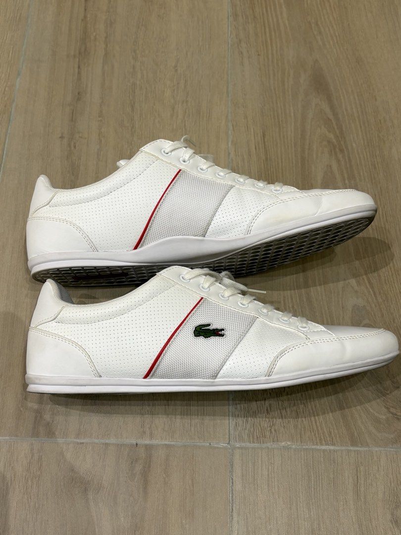 Lacoste Men's White Sneakers (Category: Sneakers) located in Taguig. Submitted by mkcortez (Listing ID 1436419301, Image 1). Description: - White Lacoste sneakers - Red accents - Lacoste logo on side and insole - Perforated design - Gray soles with red Lacoste label - White laces - Red insole.