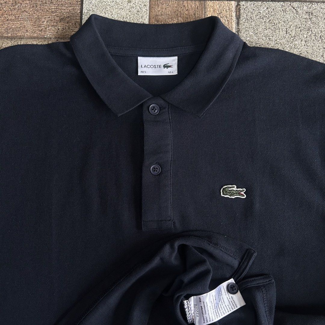 Lacoste Navy Blue Polo Shirt (Category: Tshirts & Polo Shirts ) located in Quezon. Submitted by webtothecloset (Listing ID 1436358408, Image 2). Description: - Navy blue Lacoste polo shirt - Features the iconic crocodile logo - Collared neckline - Short sleeves - Button-up placket - Comfortable fabric - Size tag visible in photos - Perfect for casual wear.