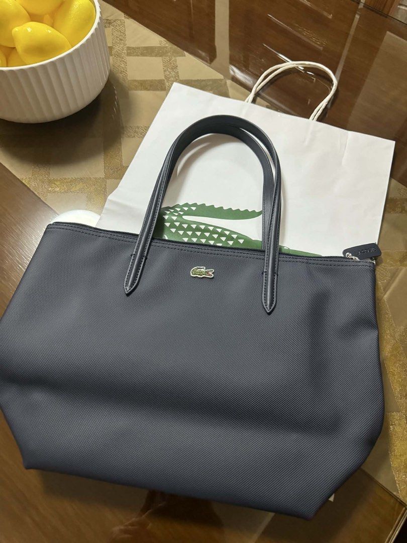 Lacoste small tote bag in blue (Category: Luxury Bags & Wallets) located in Pasig City. Submitted by femme14 (Listing ID 1436369370, Image 1). Description: Need to buy bigger size.