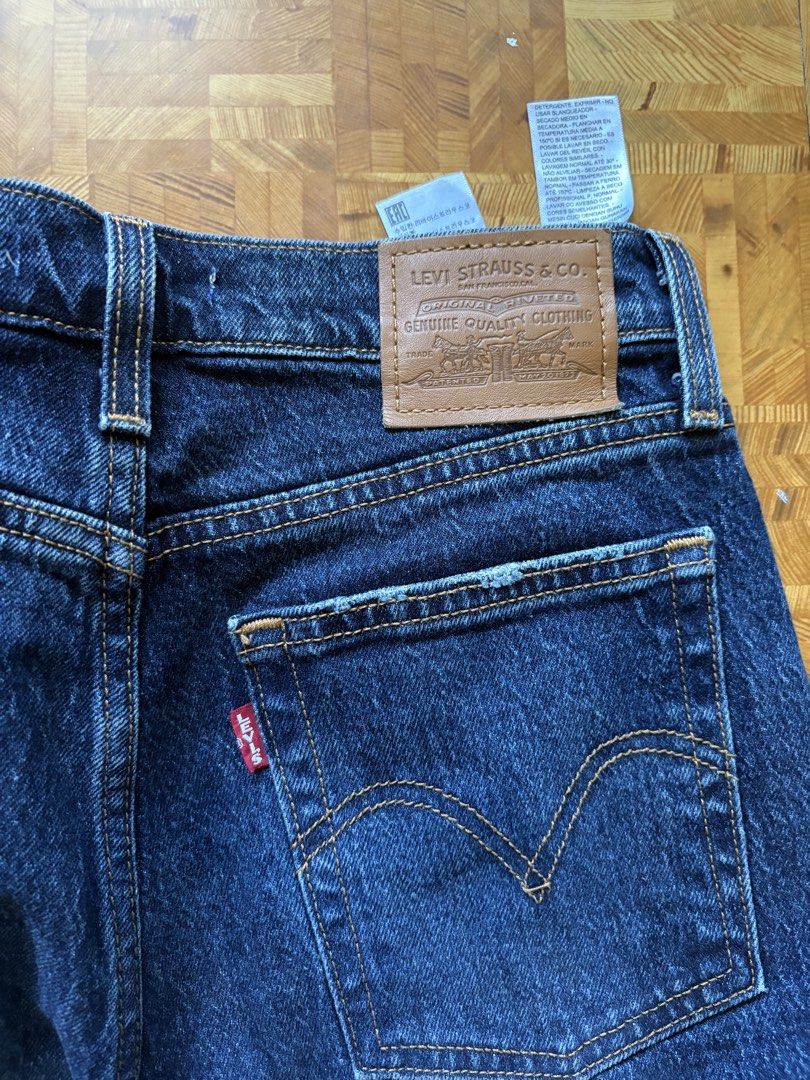 Levi's Wedge Straight Jeans Size 25 (Category: Jeans) located in Paranaque City. Submitted by eggnog852 (Listing ID 1436329928, Image 2). Description: Levi's Wedge Straight jeans in a dark wash. Features a classic five-pocket design with the Levi's leather patch on the back. The jeans have a straight leg cut with a raw hem.