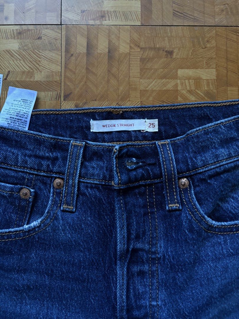 Levi's Wedge Straight Jeans Size 25 (Category: Jeans) located in Paranaque City. Submitted by eggnog852 (Listing ID 1436329928, Image 3). Description: Levi's Wedge Straight jeans in a dark wash. Features a classic five-pocket design with the Levi's leather patch on the back. The jeans have a straight leg cut with a raw hem.