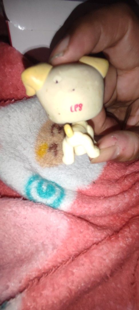 Littlest Pet Shop Dog (Category: Figurines & Statues) located in Subic. Submitted by booley (Listing ID 1436373779, Image 2). Description: - Littlest Pet Shop dog - Light yellow body and ears - Purple eyes and small black nose - "LPS" printed on the back - Small, collectible toy.