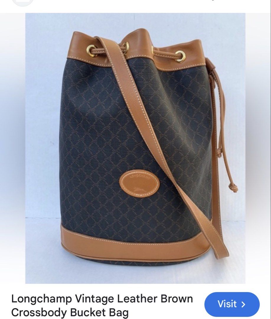 Longchamp Vintage Leather Bucket Bag (Category: Luxury Bags & Wallets) located in Rosales. Submitted by thriftingismygame (Listing ID 1436465424, Image 1). Description: - Vintage Longchamp bucket bag - Brown leather trim and strap - Drawstring closure - Crossbody strap - Brown patterned exterior - Leather logo patch - Gold-tone hardware.