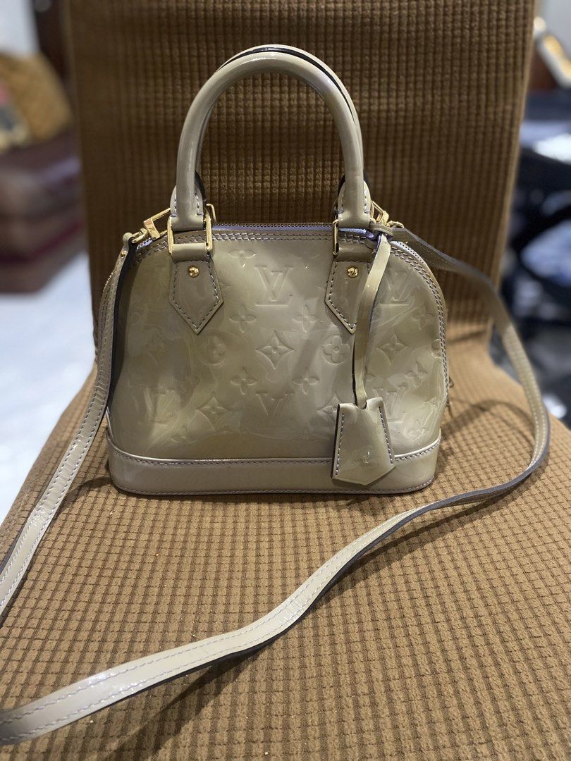 Louis Vuitton Alma BB Vernis Handbag (Category: Luxury Bags & Wallets) located in Cadiz. Submitted by saveandstyleph (Listing ID 1436415933, Image 1). Description: - Authentic Louis Vuitton Alma BB - Light-colored exterior with LV monogram - Top handle and detachable shoulder strap - Light purple interior - Includes small tag - Gold-tone hardware - Compact and stylish design.