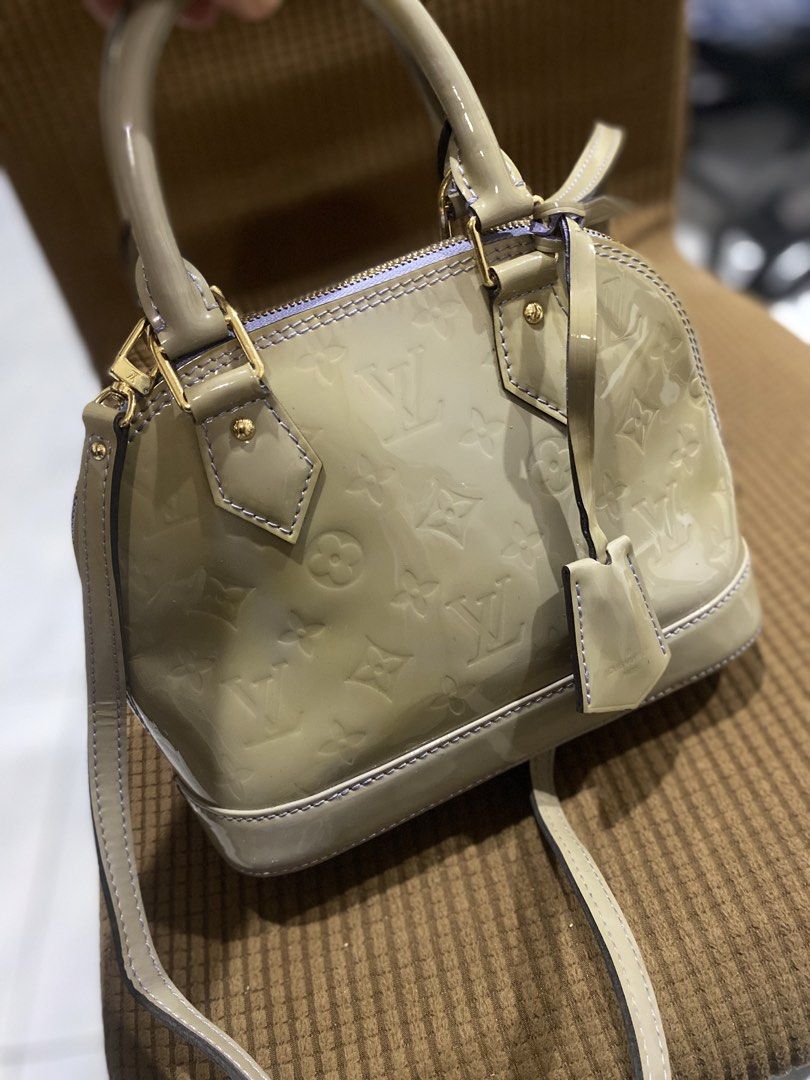 Louis Vuitton Alma BB Vernis Handbag (Category: Luxury Bags & Wallets) located in Cadiz. Submitted by saveandstyleph (Listing ID 1436415933, Image 3). Description: - Authentic Louis Vuitton Alma BB - Light-colored exterior with LV monogram - Top handle and detachable shoulder strap - Light purple interior - Includes small tag - Gold-tone hardware - Compact and stylish design.