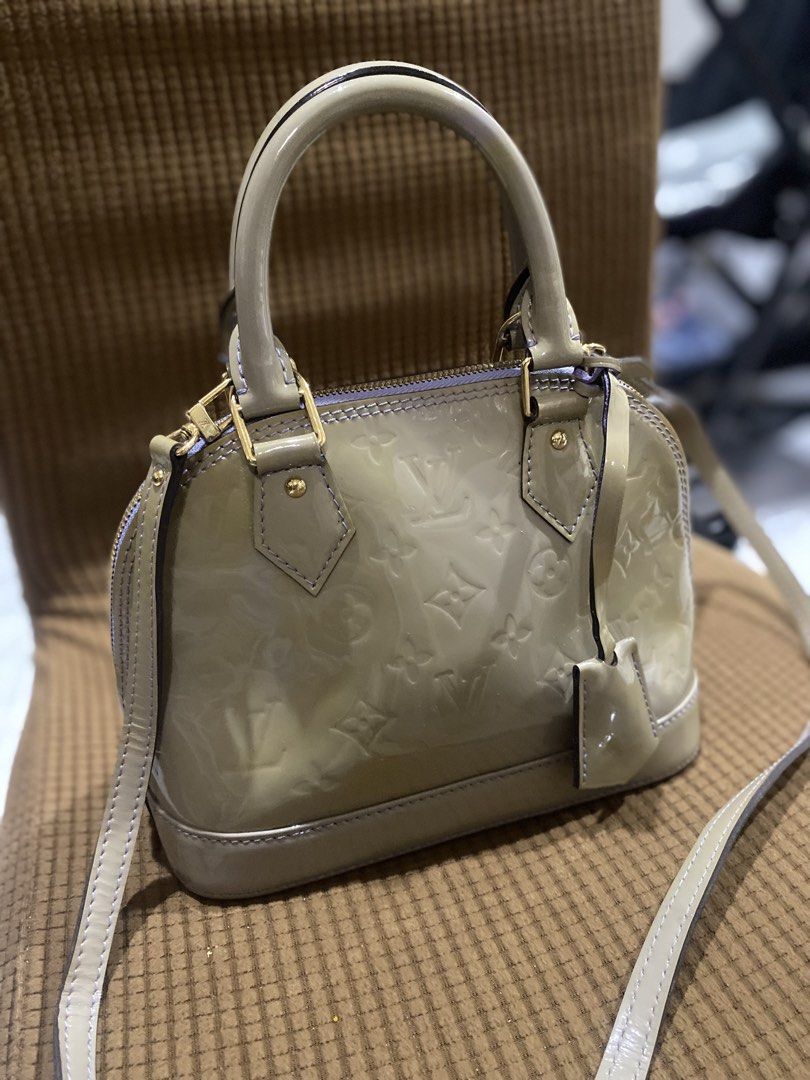Louis Vuitton Alma BB Vernis Handbag (Category: Luxury Bags & Wallets) located in Cadiz. Submitted by saveandstyleph (Listing ID 1436415933, Image 2). Description: - Authentic Louis Vuitton Alma BB - Light-colored exterior with LV monogram - Top handle and detachable shoulder strap - Light purple interior - Includes small tag - Gold-tone hardware - Compact and stylish design.