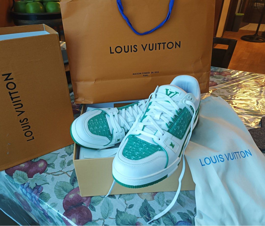 Louis Vuitton LV Trainer Green White Sneakers (Category: Sneakers) located in Paranaque City. Submitted by tinaascloset (Listing ID 1436296486, Image 2). Description: - Authentic Louis Vuitton LV Trainer sneakers - Color: Green and White - Includes original box, dust bag, and shopping bag - Made in Italy - Features LV logo on side and tongue - White laces - Green and white sole With certificate of authenticity .