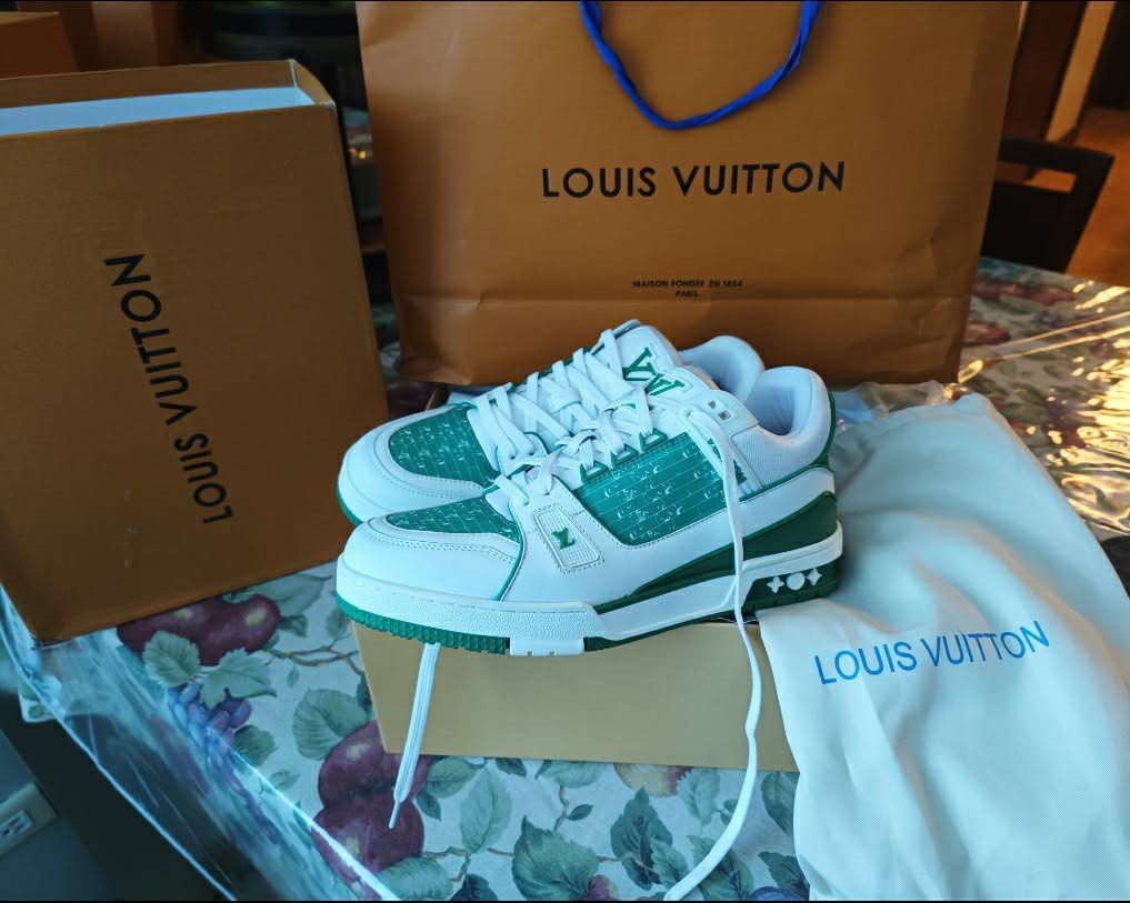 Louis Vuitton LV Trainer Green White Sneakers (Category: Sneakers) located in Paranaque City. Submitted by tinaascloset (Listing ID 1436296486, Image 1). Description: - Authentic Louis Vuitton LV Trainer sneakers - Color: Green and White - Includes original box, dust bag, and shopping bag - Made in Italy - Features LV logo on side and tongue - White laces - Green and white sole With certificate of authenticity .