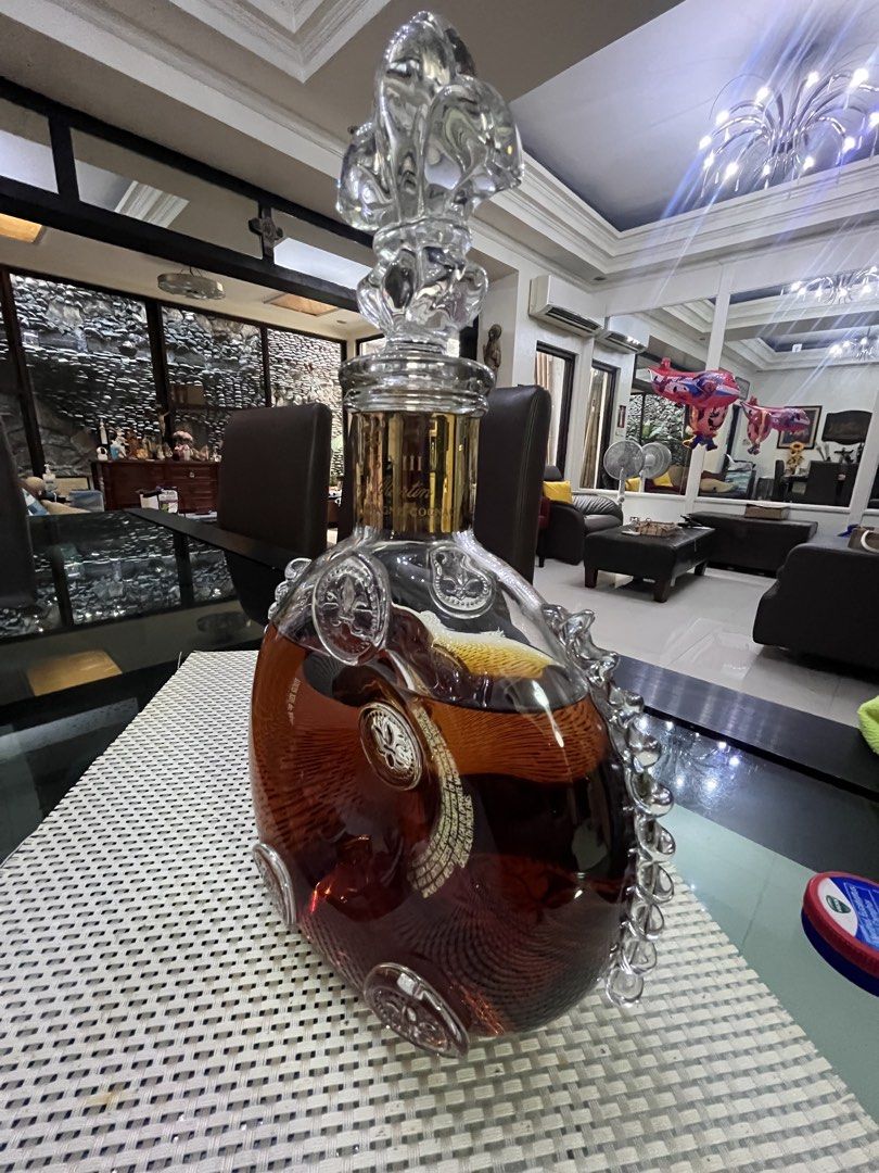 Louis XIII Grande Champagne Cognac (Category: Looking For) located in Pasig City. Submitted by jorgeboy9748 (Listing ID 1436348024, Image 2). Description: Beautiful bottle of Louis XIII Grande Champagne Cognac. The bottle has a unique shape with intricate glass detailing and a decorative stopper. The bottle has gold accents and the brand name is clearly visible. A luxurious addition to any collection..